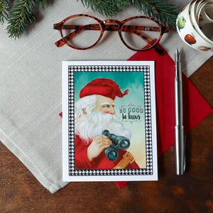 a christmas card with a picture of a santa holding a camera