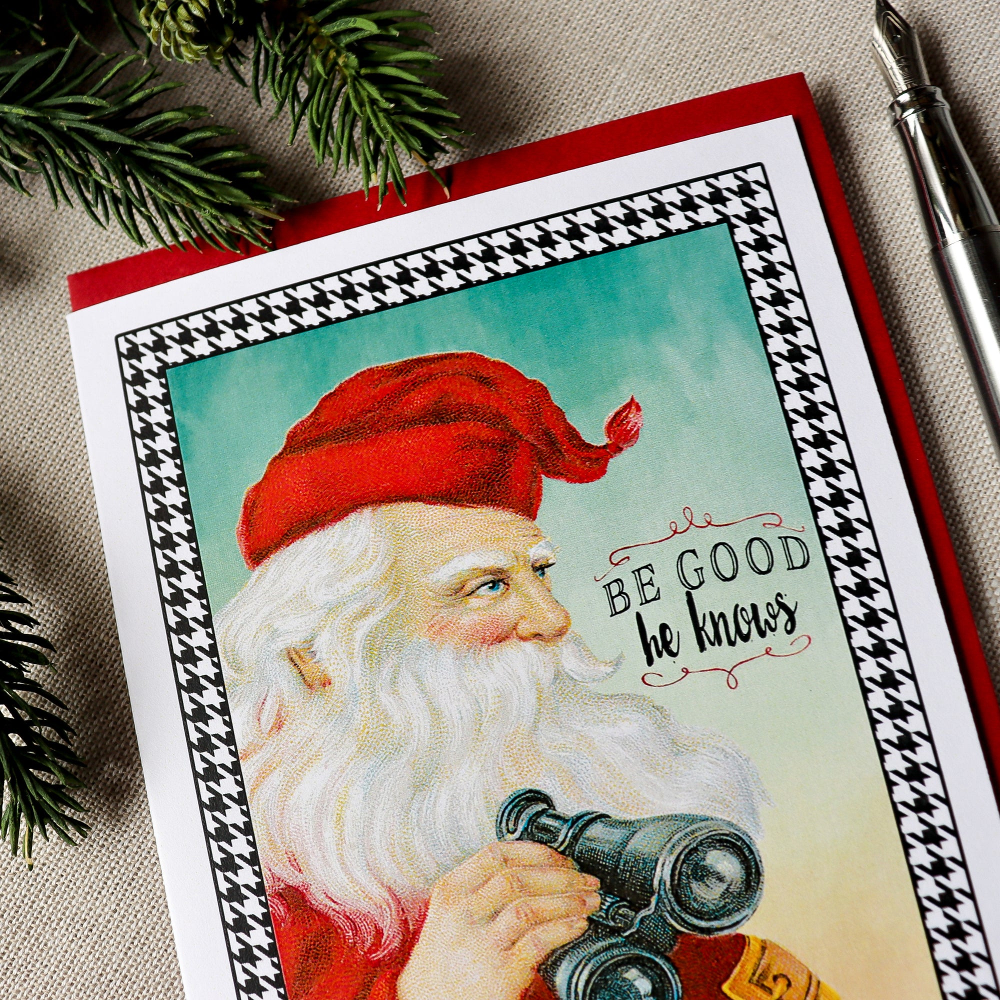 a christmas card with a picture of santa holding a telescope