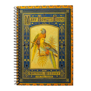 A travel-sized notebook featuring a vintage book cover: Mary Howitt&#39;s Poems of Natural History for the Young. Features a framed illustration of two colorful parrots. Colors are deep blue, orange, gold and green.