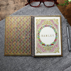 Handmade travel notebook (5 x 7 inches) featuring cover of a vintage copy of Hamlet by William Shakespeare. Colors: bronze and jewel tones- green red, gold, blue. Floral Patterns and intricate frame.